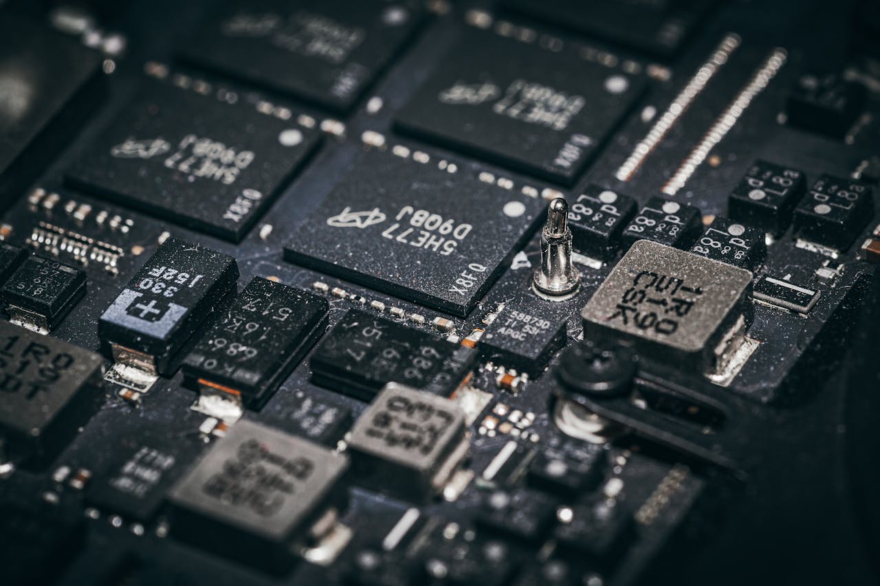 Contact Detailed close-up of electronic microchips on a circuit board, showcasing technology and engineering intricacies.